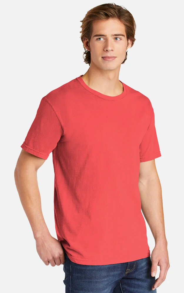 Young man with light brown hair wearing a red t-shirt and blue jeans, standing against a plain white background.