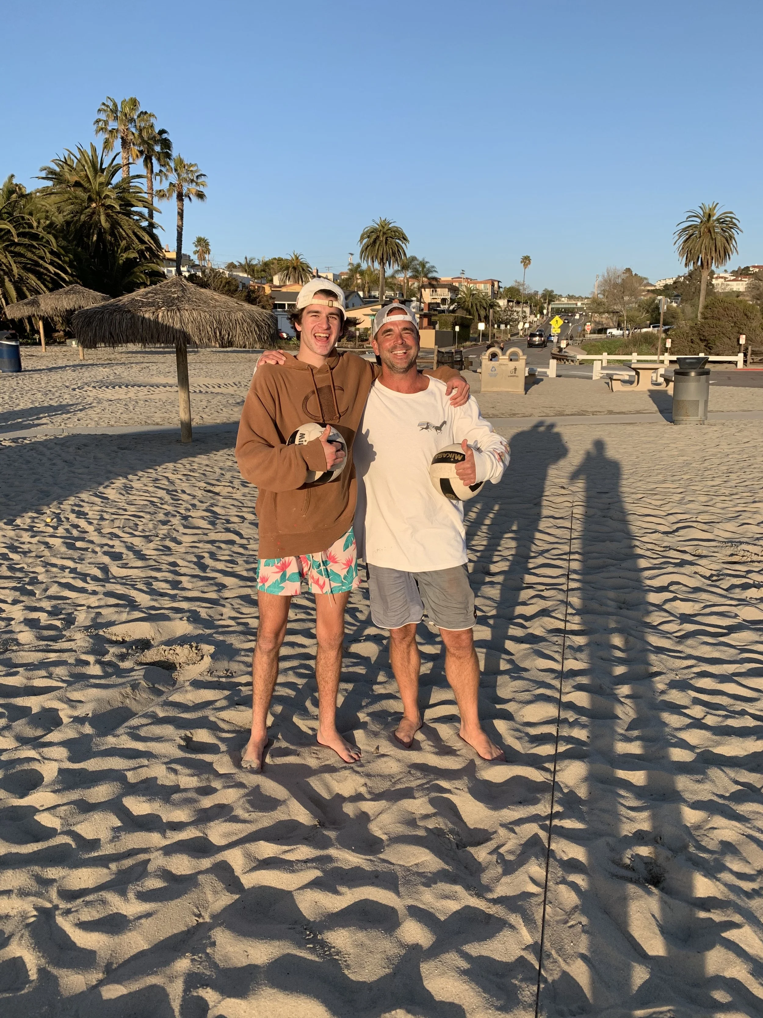 Nick Petro with a student on the beach in San Diego