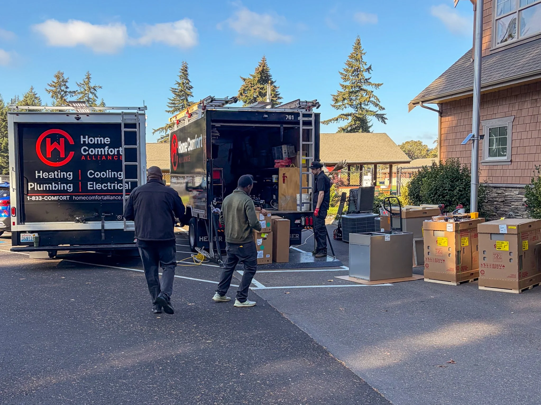 Crews unload the donated heating and cooling equipment outside the American Lake Veterans Golf Course clubhouse.