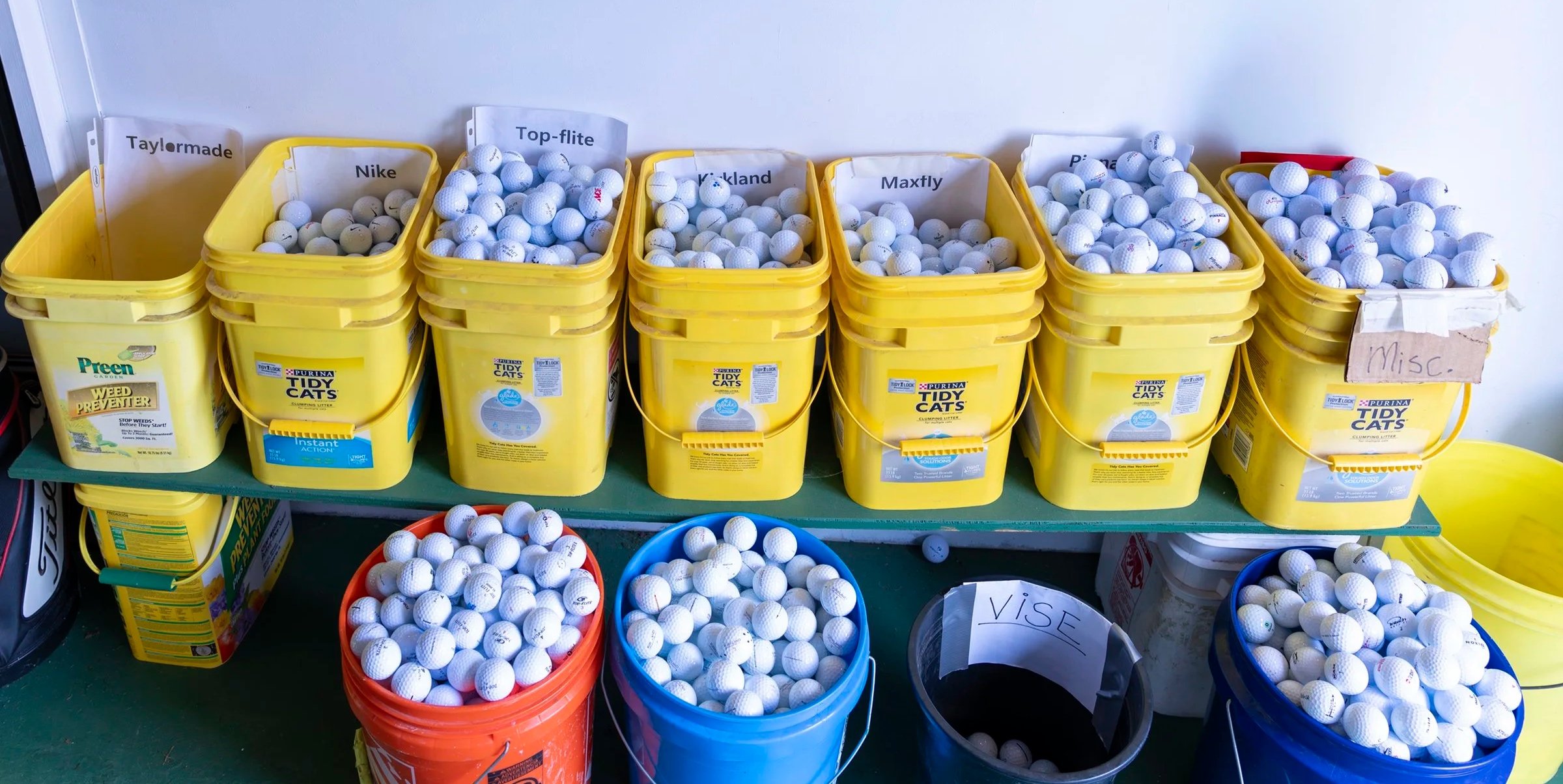 Buckets of sorted golf balls in the Area 51 equipment workshop.