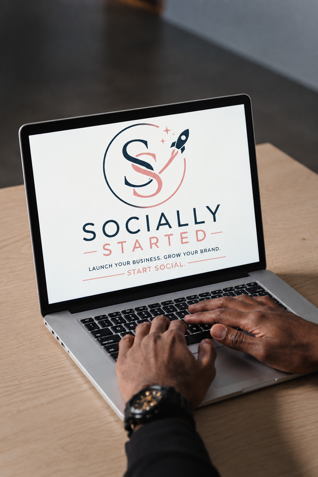 A man looks at Socially Started's logo on a computer screen.