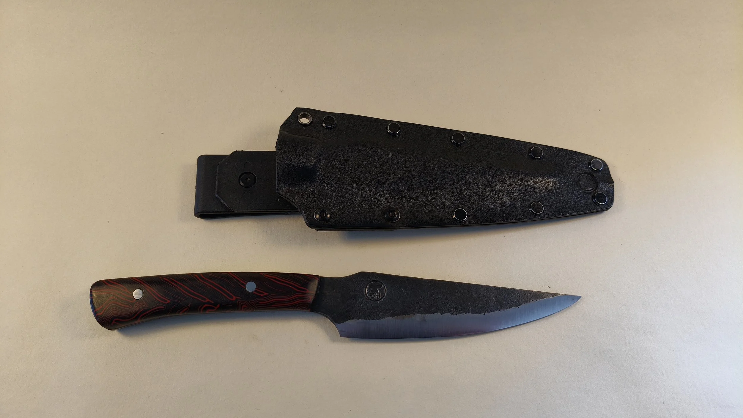 Custom Hunter #3  1095 HC steel with red/black Micarta handle and Kydex sheath
 - Available for sale at the Raglan Arts Weekend  24-26 Oct 2026