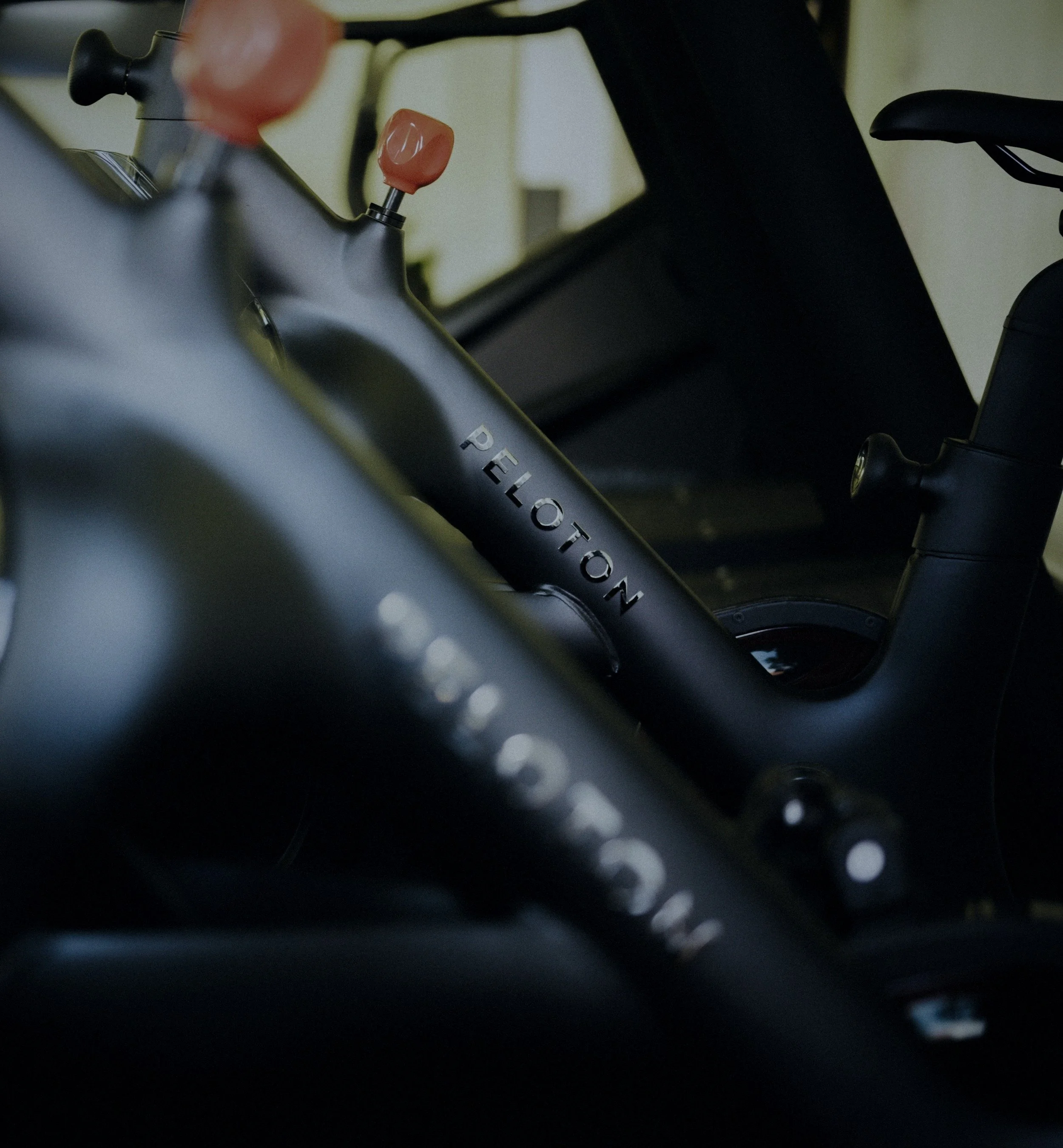 Close-up of a motorcycle handlebar with a pink inner tube handle grip and black control levers in a dark environment.