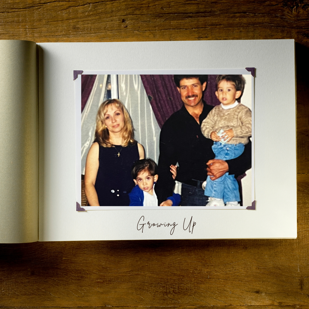 A family portrait of four people standing in front of purple and white curtains. A woman with blonde hair and a black sleeveless top, a man with dark hair and mustache in a black shirt, a young girl with dark hair in a blue jacket, and a young boy with dark hair in a beige sweater hold a small object. The photo is titled 'Growing Up' at the bottom.