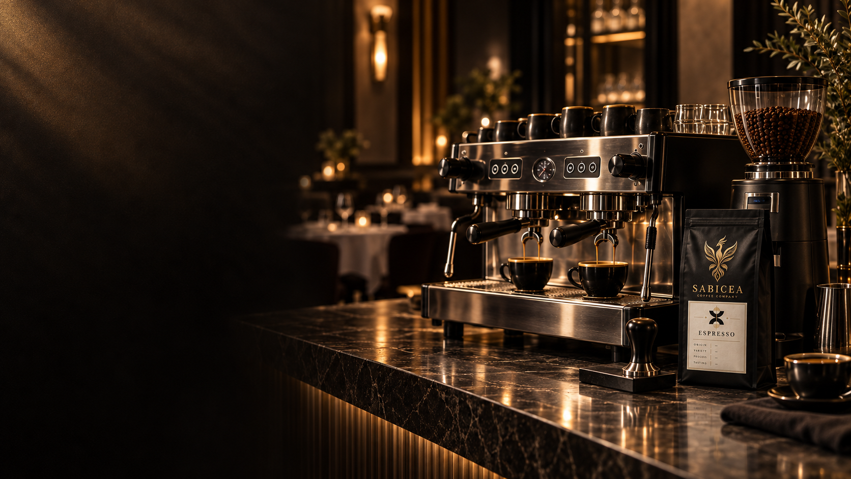 A professional espresso machine on a dark marble counter with cups underneath, surrounded by a bag of coffee beans and a coffee grinder in a warmly lit, elegant setting.