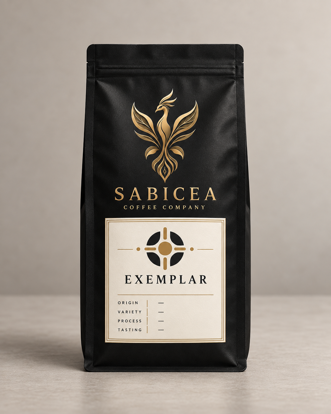 A black coffee bag with a gold phoenix logo and the words "SABICEA Coffee Company" on it. The label states the coffee is "Exemplar" and indicates sections for origin, variety, process, and tasting notes.