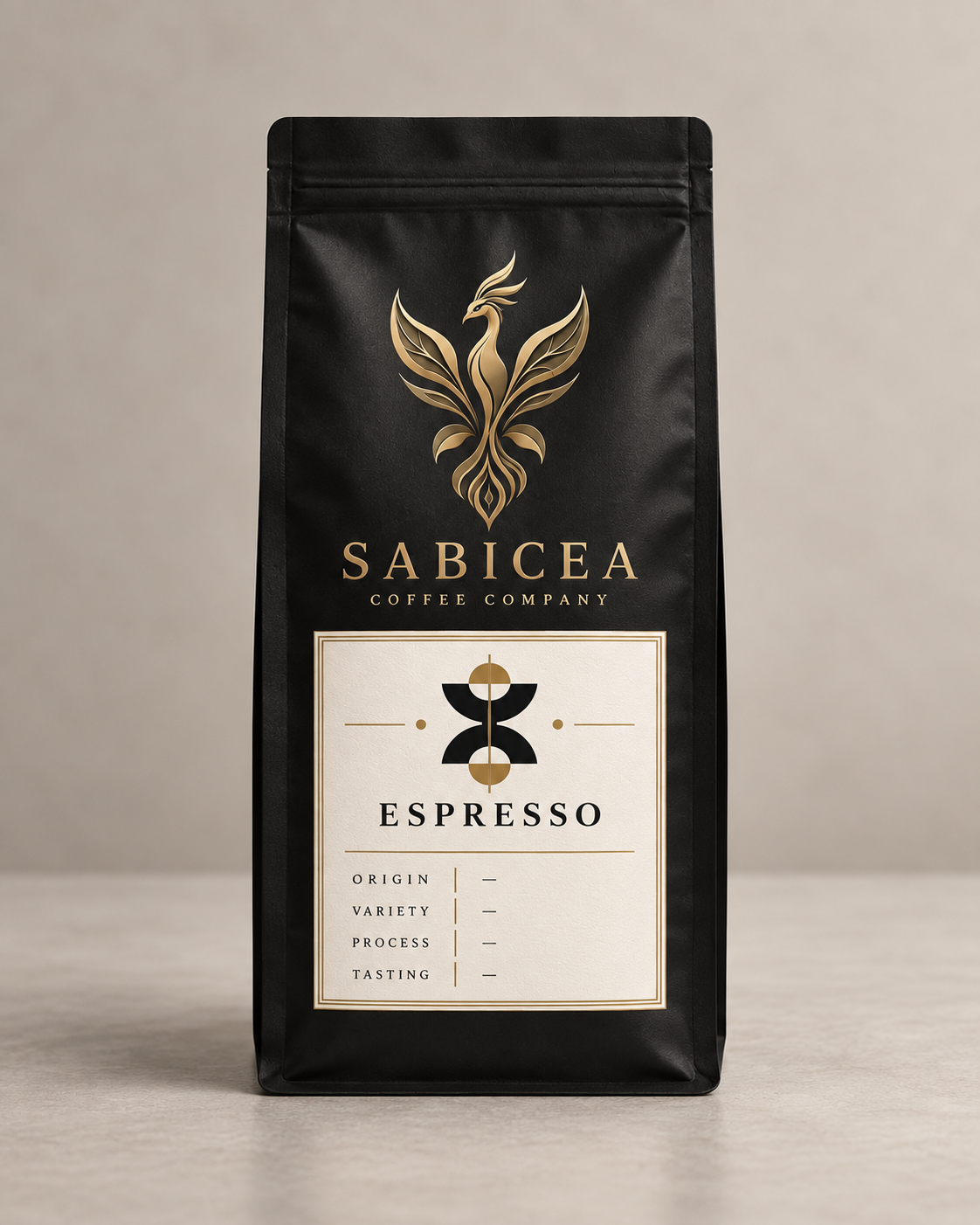Black coffee bag with gold and white label displaying the brand name 'Sabicea Coffee Company' and a stylized phoenix logo. The label indicates the coffee variety as 'Espresso' with sections for origin, variety, process, and tasting notes.