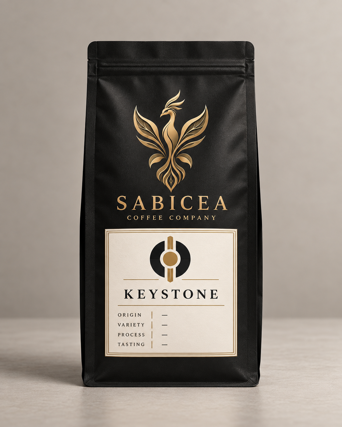Black bag of Sabicea Coffee Company Keystone coffee with gold logo and label.