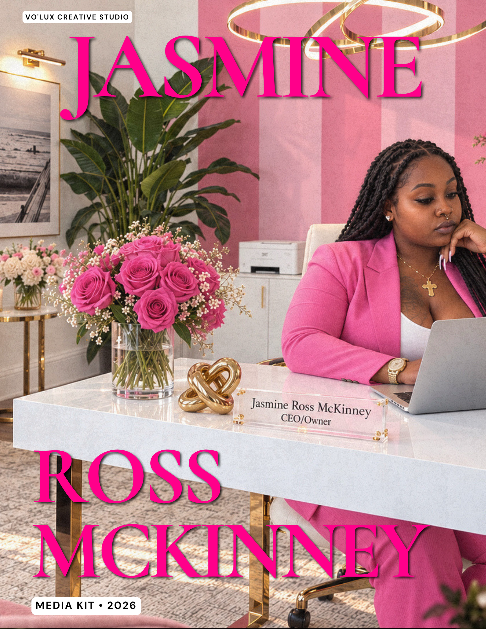 A woman with dark skin, wearing a pink blazer and gold jewelry, sitting at a white desk with a laptop. Behind her is a pink, striped wallpaper, and nearby are decorative flowers, a large green plant, and a modern gold lamp. The text overlay reads "Jasmine Ross McKinney."