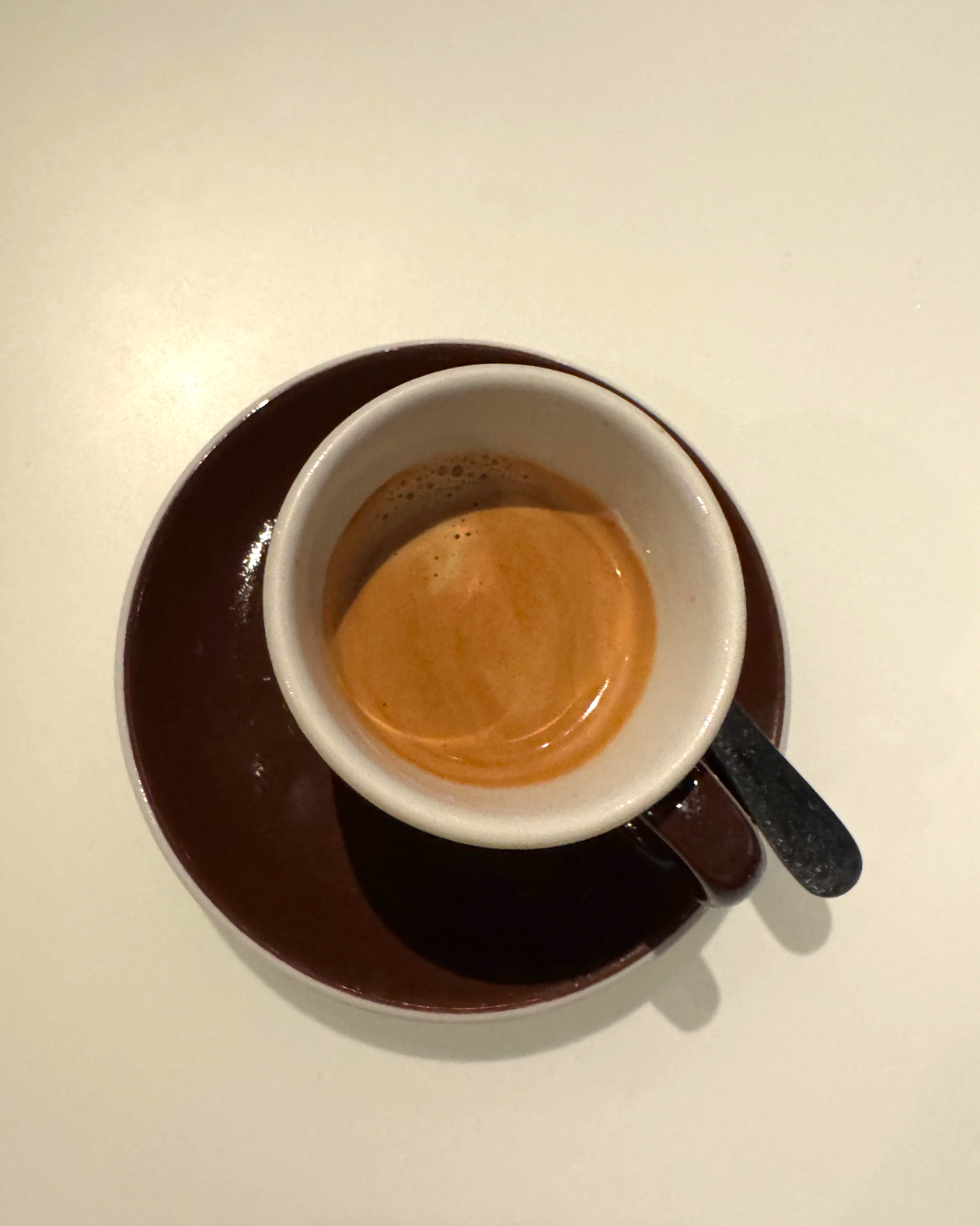 An espresso in a brown cup