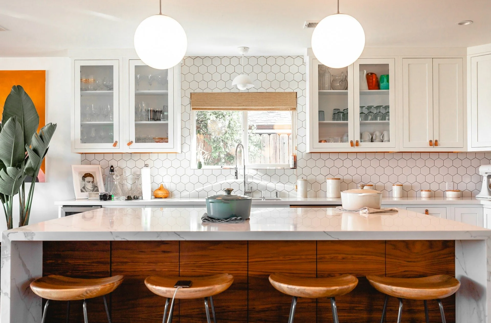A modern kitchen with four-brown-stools