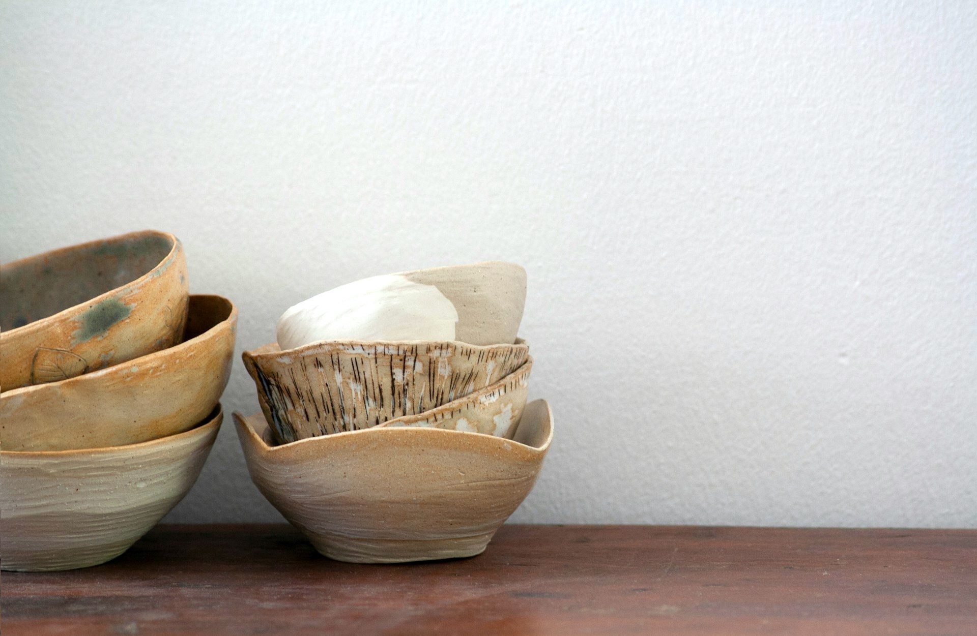 A group of bowls sitting on top of a wooden-table