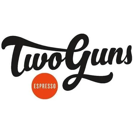 Logo for Two Guns Espresso featuring the text 'Two Guns' in black script and 'Espresso' in white inside a red circle