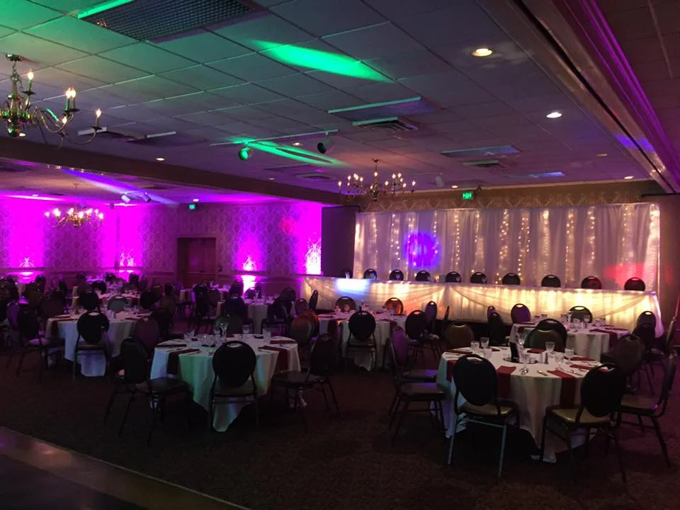 Wedding reception at Halls Guesthouse with purple uplighting and an illuminated head table.
