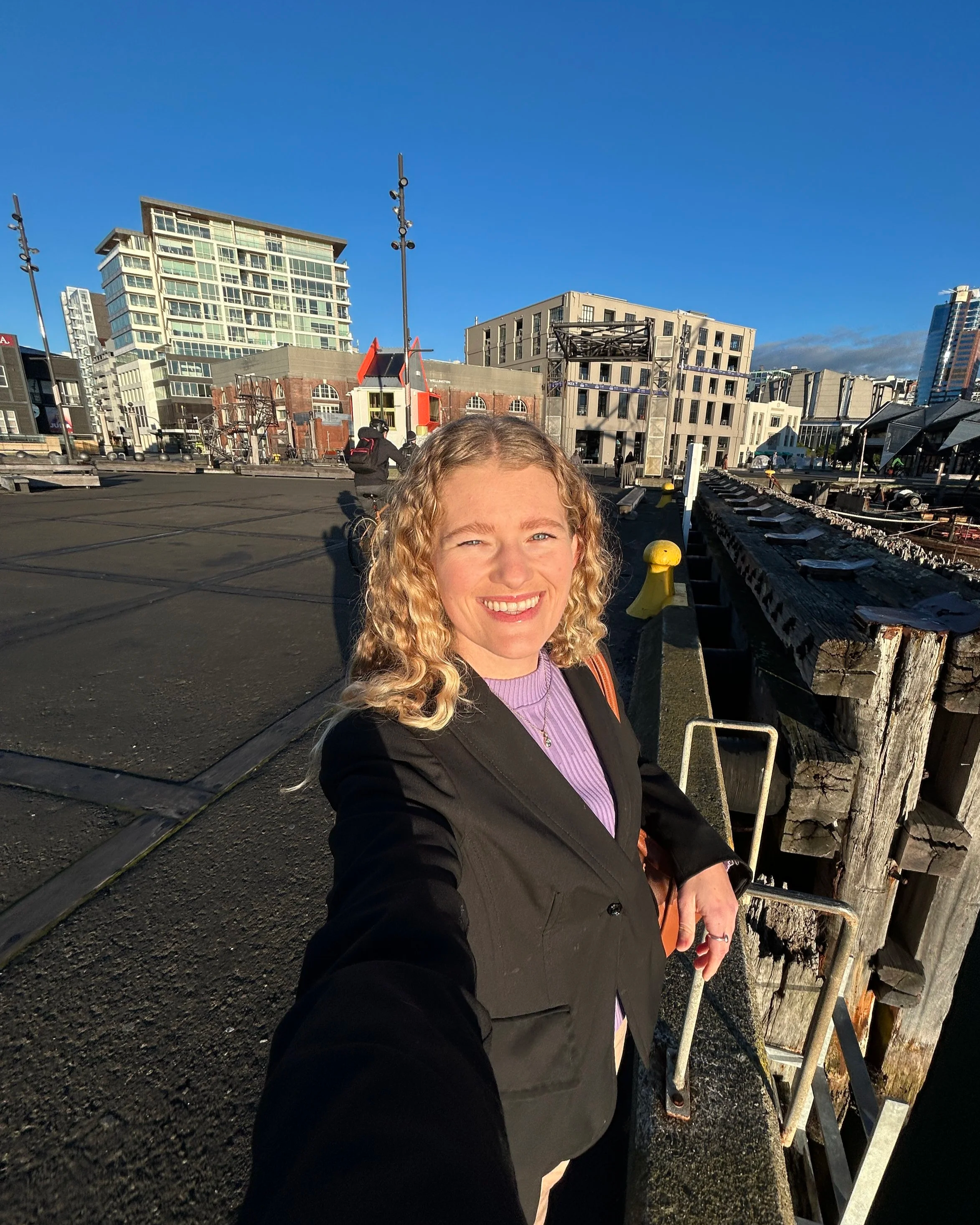 Woman dressed in blazer on Wellington waterfront
