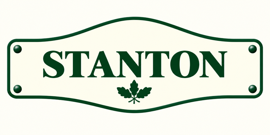 A street sign with the name 'Stanton' in green, featuring a small green leaf emblem below the name.