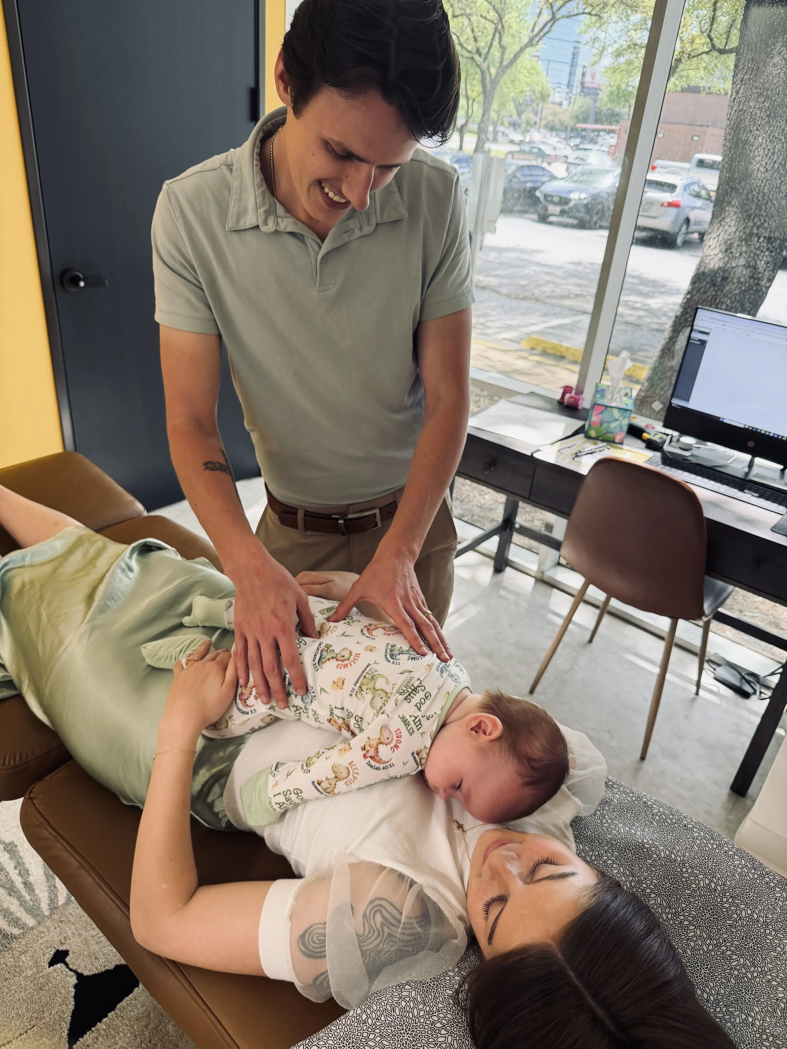 Dr. Brayden Hay adjusting a young boy while his family waits nearby in Woodward, Oklahoma