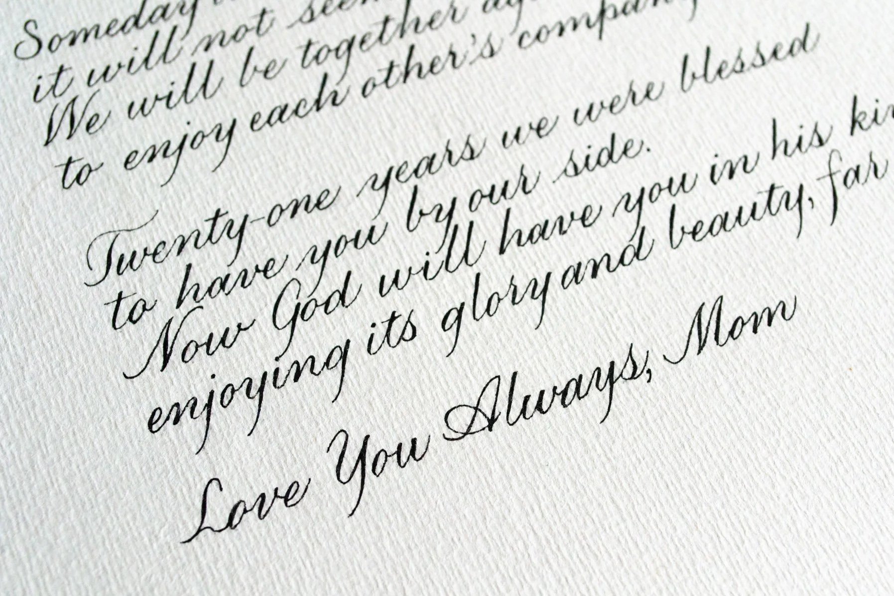 Close-up of a handwritten note in cursive script on textured paper, expressing love and gratitude from a mother to her children.