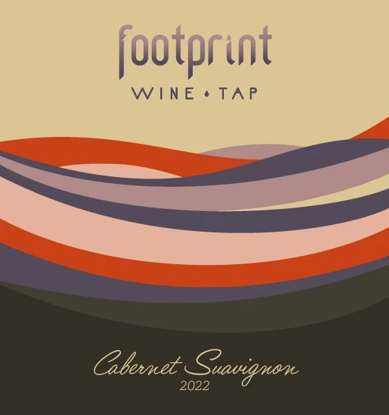 Design of a wine label featuring abstract wavy lines in shades of purple, red, and beige. The label reads 'footprint WINE TAP' at the top and 'Cabernet Sauvignon 2022' at the bottom.
