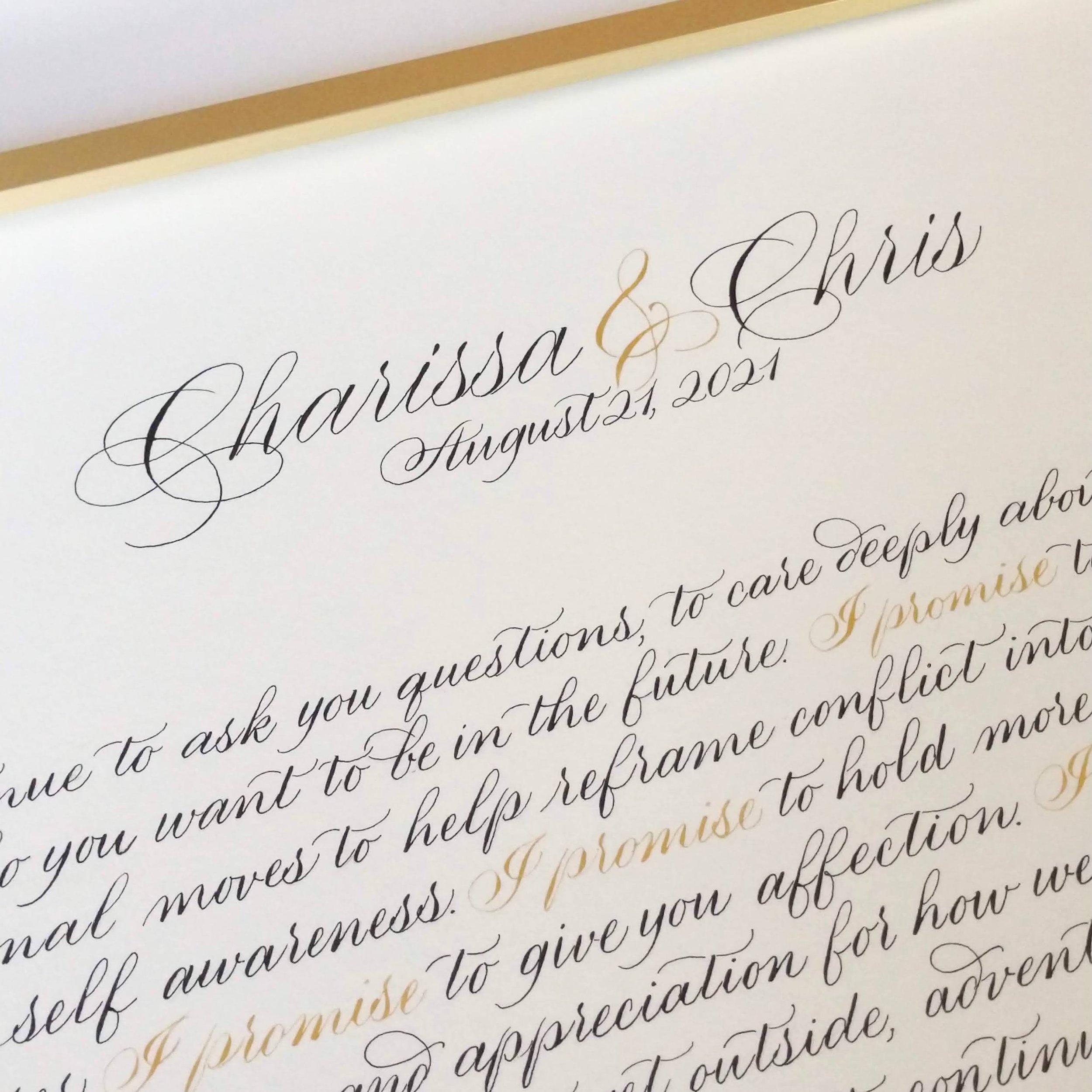 Close-up view of a wedding or formal invitation card with elegant black and gold calligraphy, listing the names 'Louisa & Chris' and a date 'August 21, 2021'.