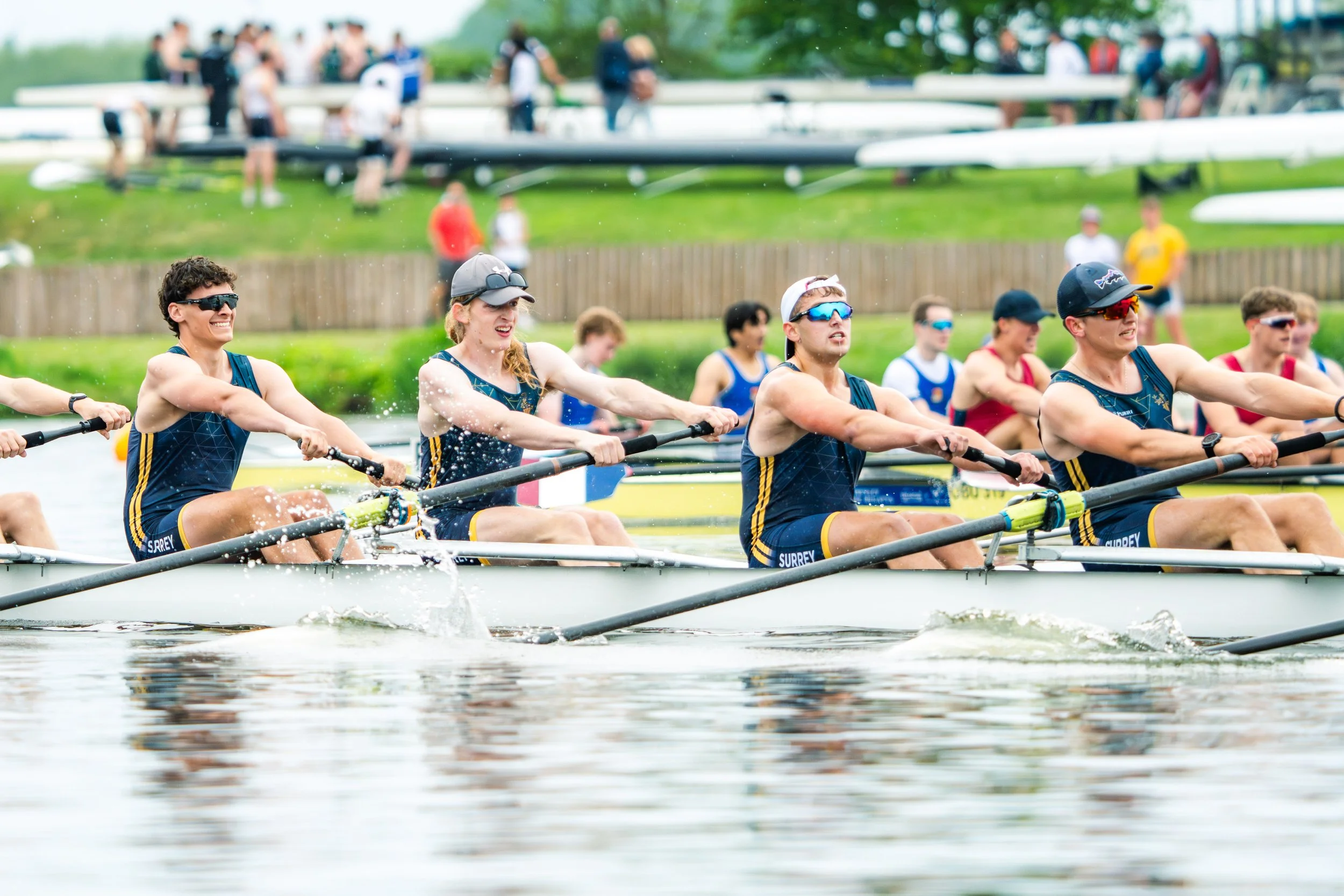 A team of rowers wearing blue uniforms with