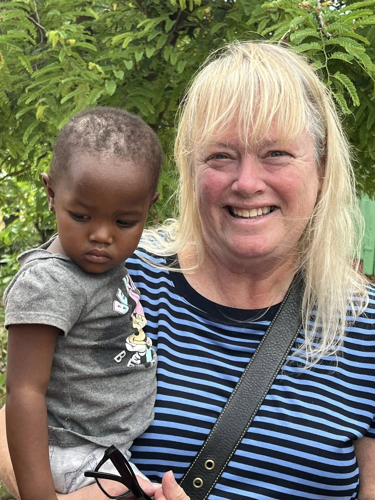 Photo of parishioner holding child in the Dominican Republic on mission trip