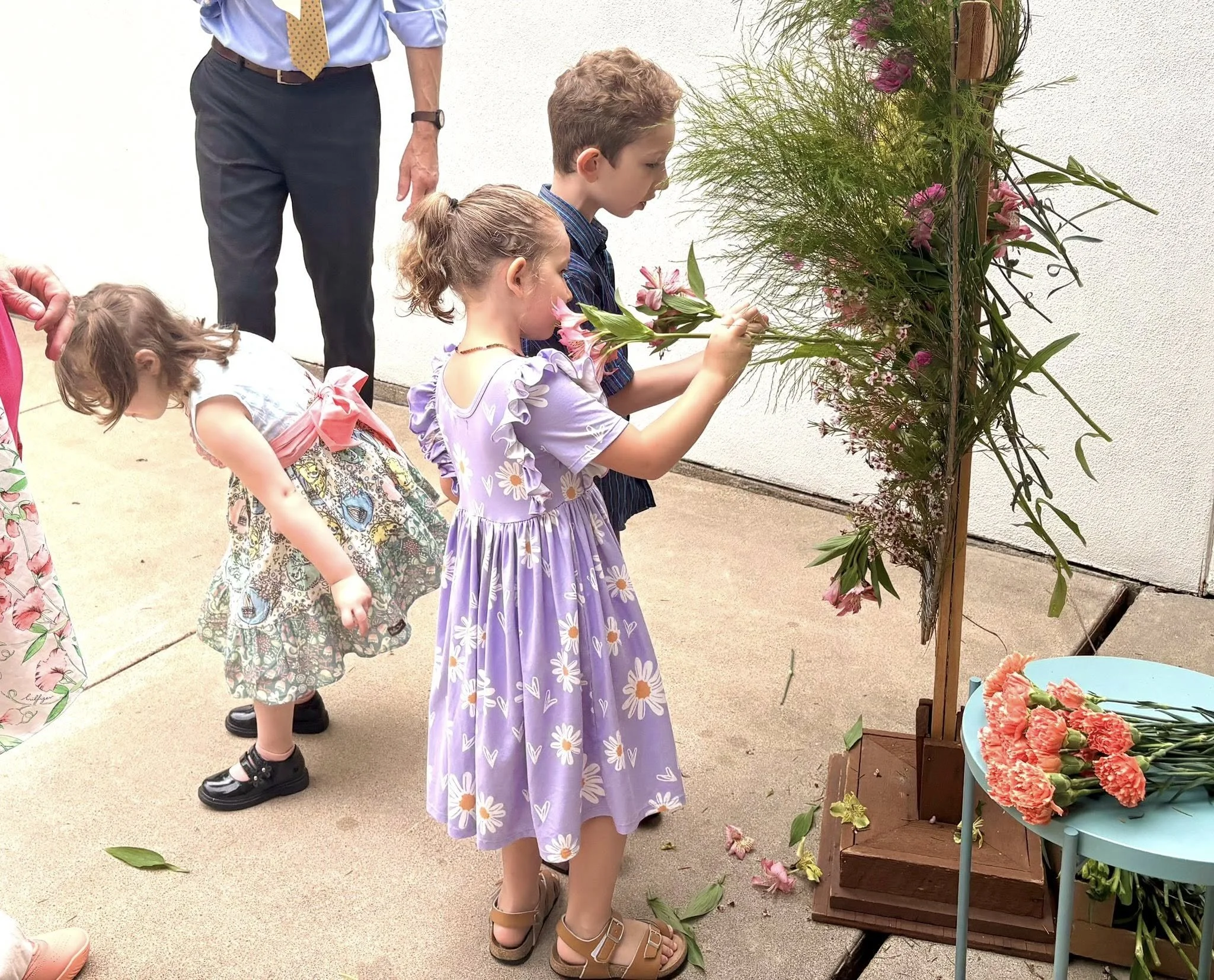 Photo of children putting flowers on Easter cross