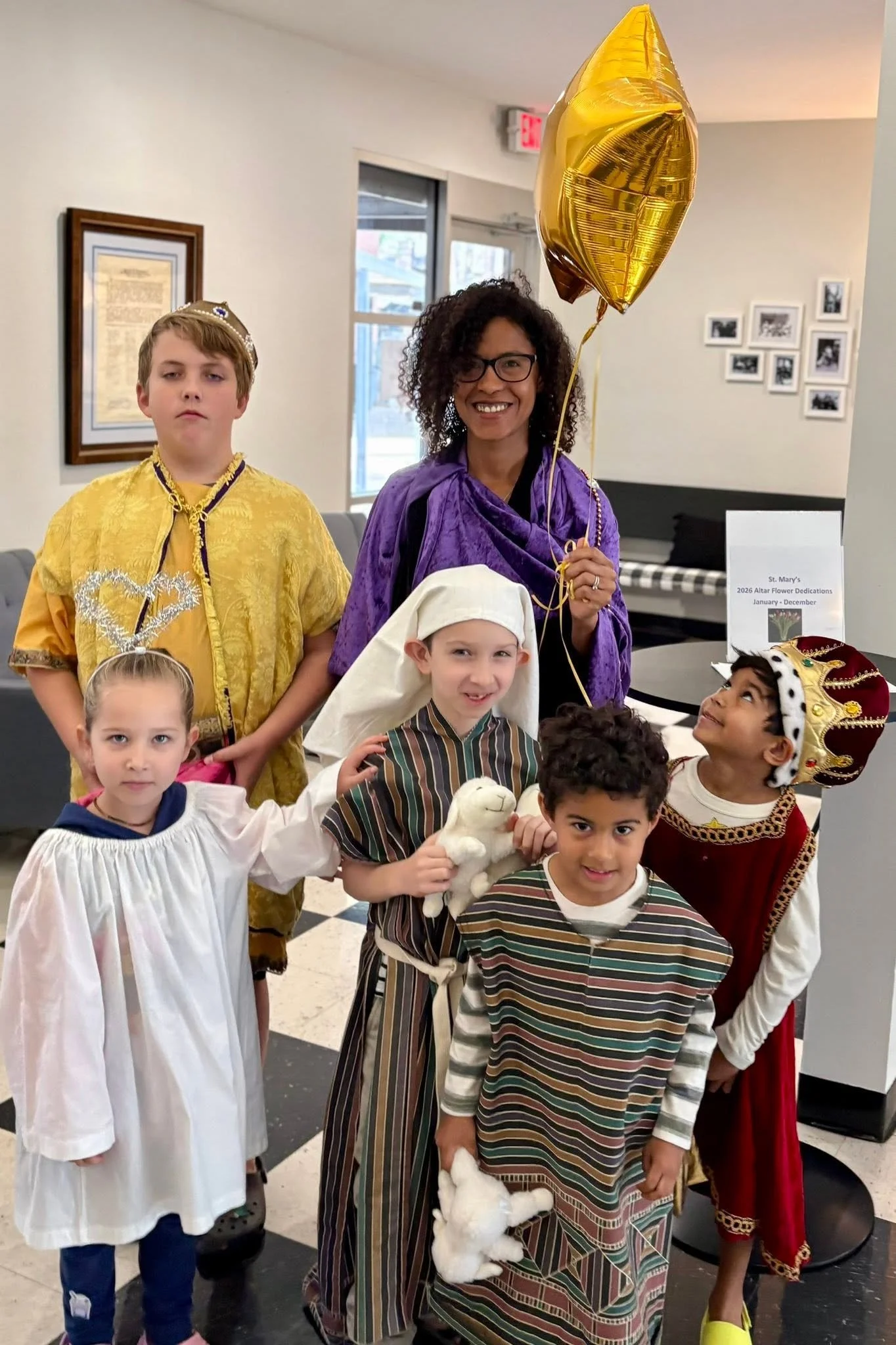 Photo of young woman and children preparing for the Epiphany Pageant
