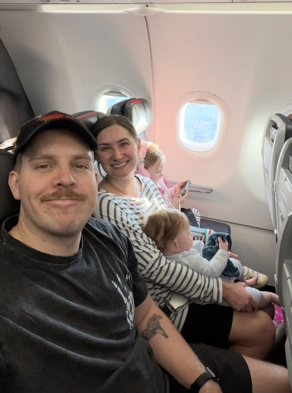 Family of four on a flight with two young kids