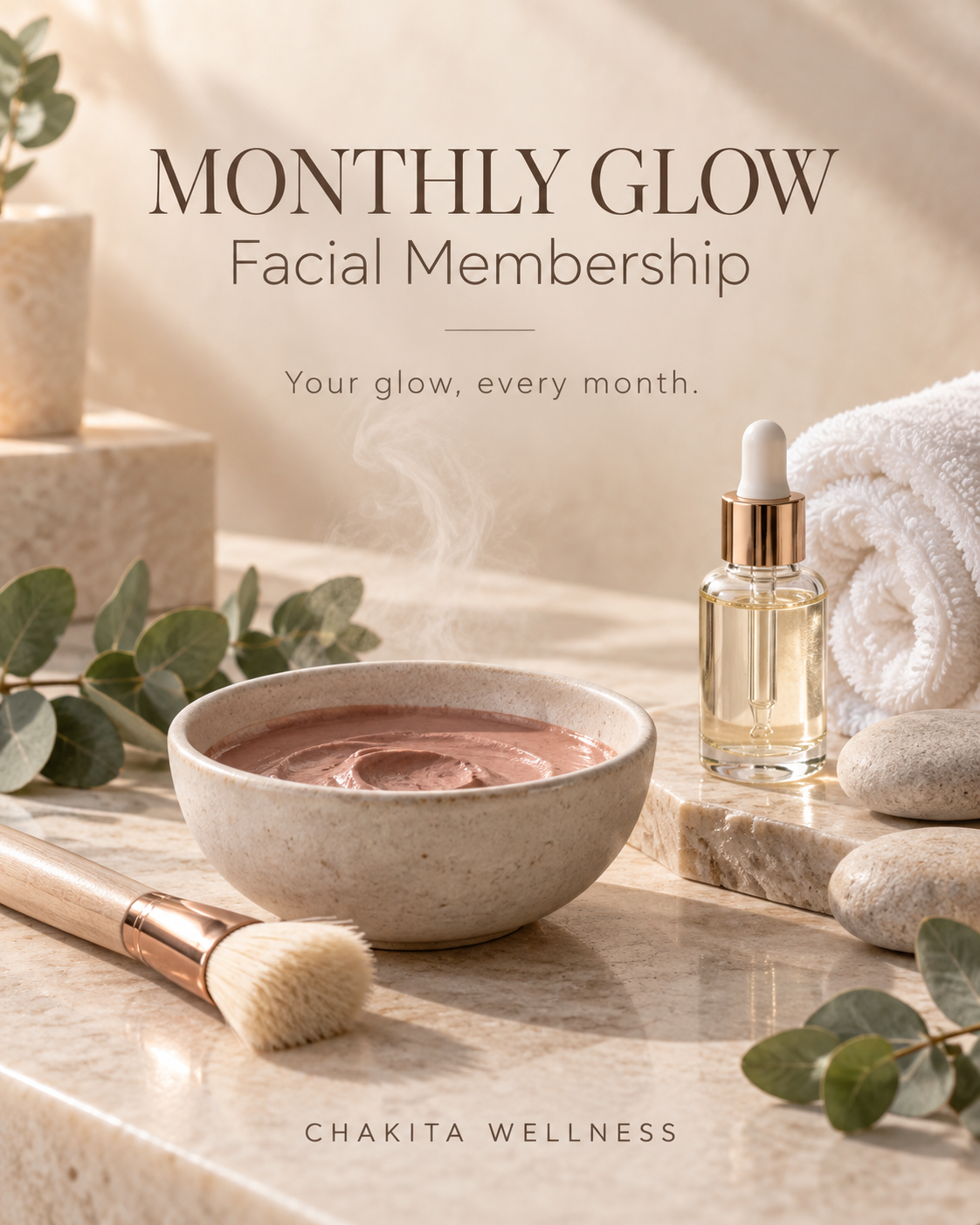 A promotional image for Chakita Wellness offering a monthly glow facial membership. The image features a beige marble countertop with a bowl of steaming facial mask, a rolled white towel, a dropper bottle of facial serum, a facial brush, some rocks, and greenery. The text highlights the monthly glow facial membership and its benefits.