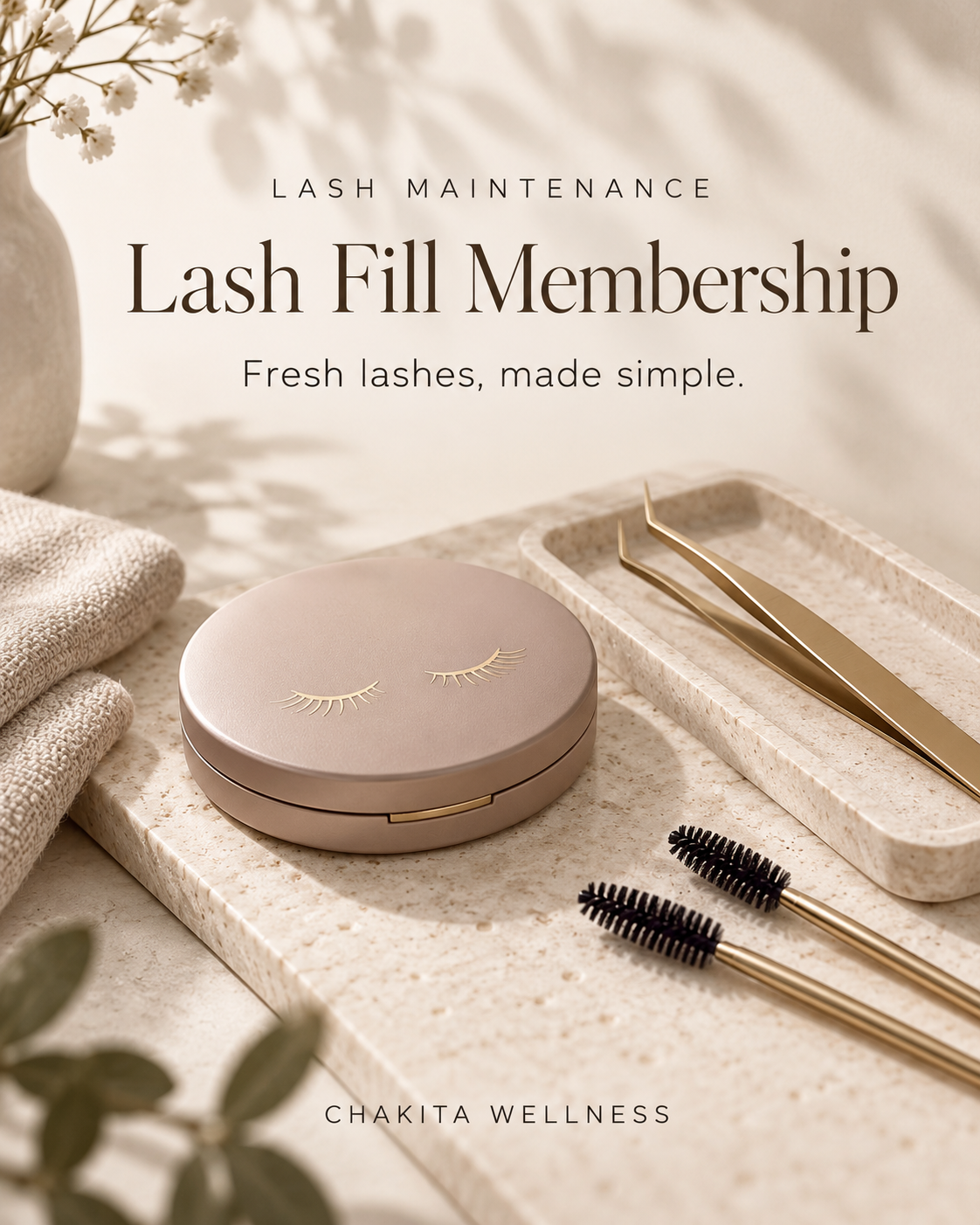 A promotional image for Lash Maintenance Lash Fill Membership by Chakita Wellness, featuring a pink round case with eyelash design, two gold tweezers, two mascara brushes, a textured beige towel, and a small vase with white flowers on a beige marble surface.