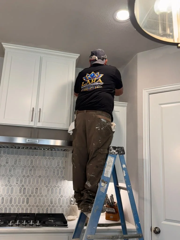 Lara Home & Commercial Services technician completing cabinet and finish work in a residential kitchen.