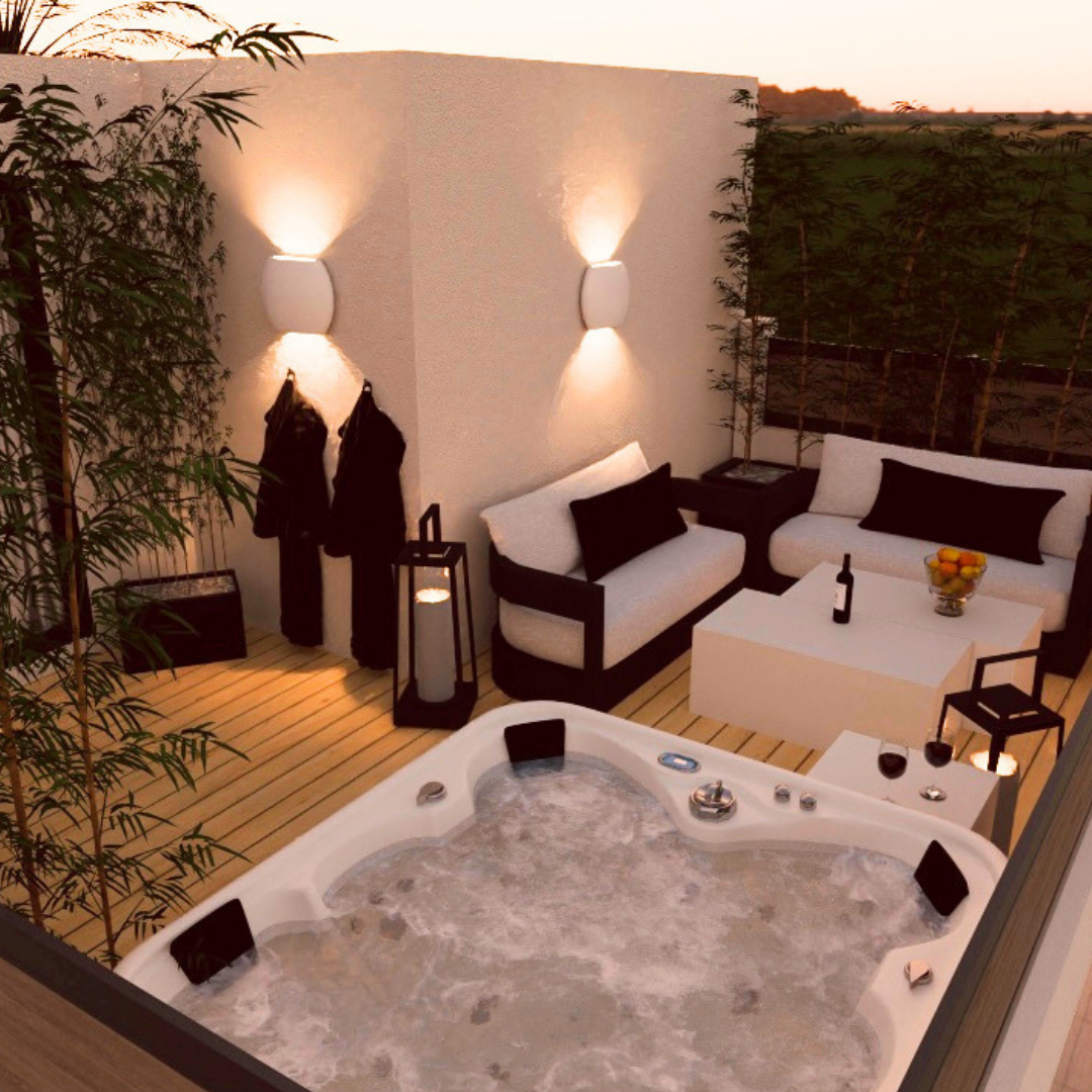 Área de terraza con muebles blancos, una tina de hidromasaje con agua, plantas, una mesa con frutas y bebidas, ambiente iluminado