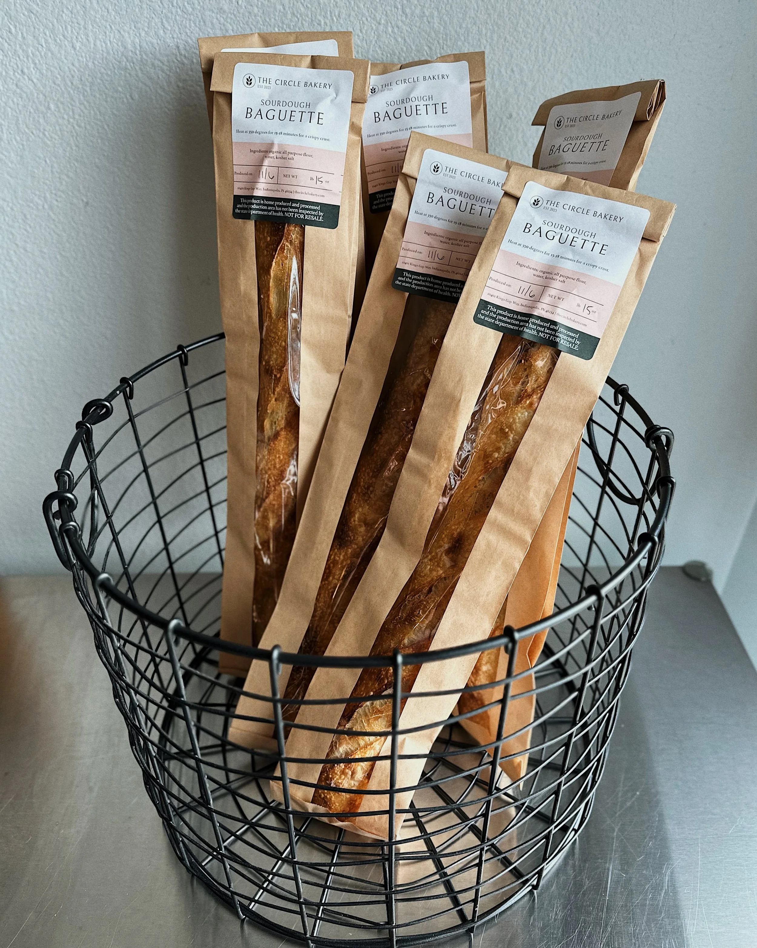 Bags of sourdough baguettes in a wire basket