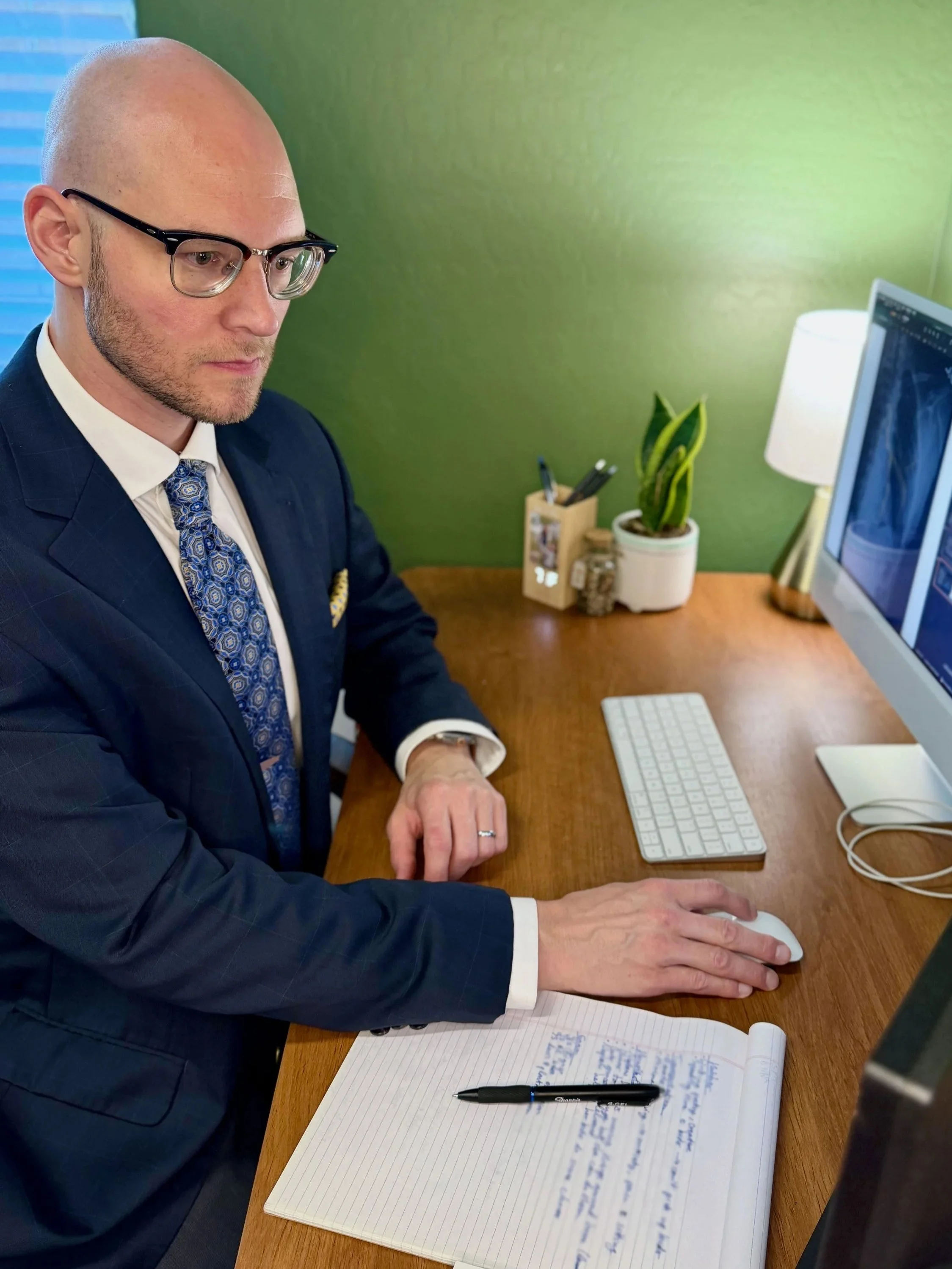 Dr. Jared Griffard, MD, FACS, CLCP reviewing medical records
