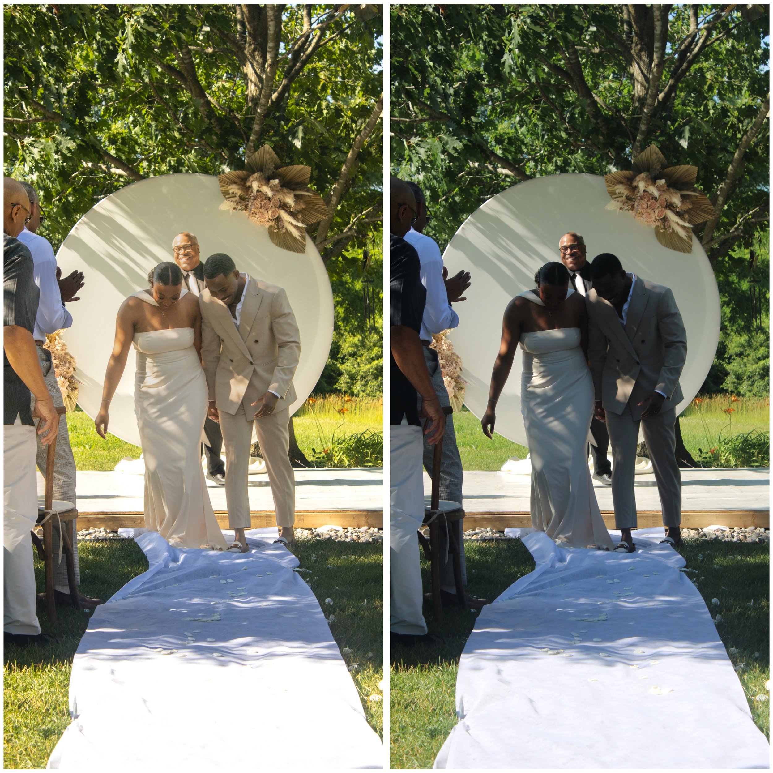 A wedding ceremony taking place outdoors under a canopy of trees, with a bride and groom standing together and surrounded by officiants and guests. Floral decorations are visible above them and a white fabric runner on the ground.