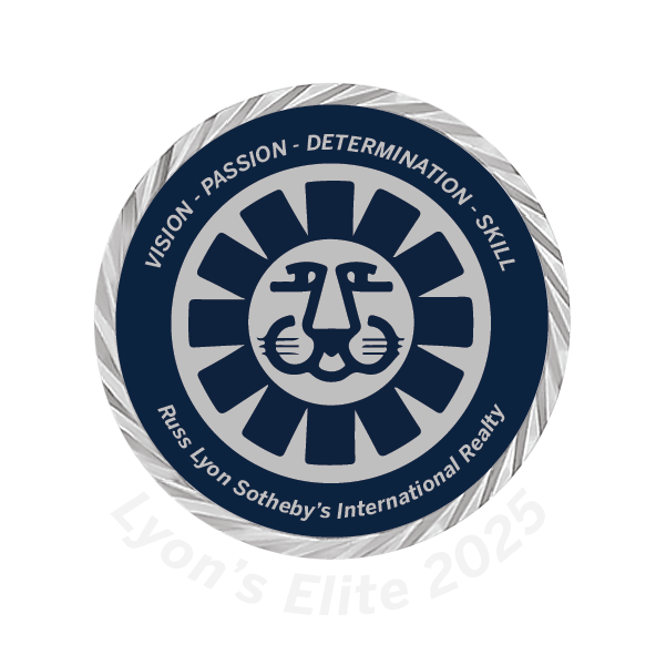 A circular award badge for Lycon's Elite 2025 with a lion's face logo in the center, surrounded by the words 'Vision', 'Passion', 'Determination', 'Skill', and 'Russ Lyon Sotheby's International Realty'.  The Kolanders.