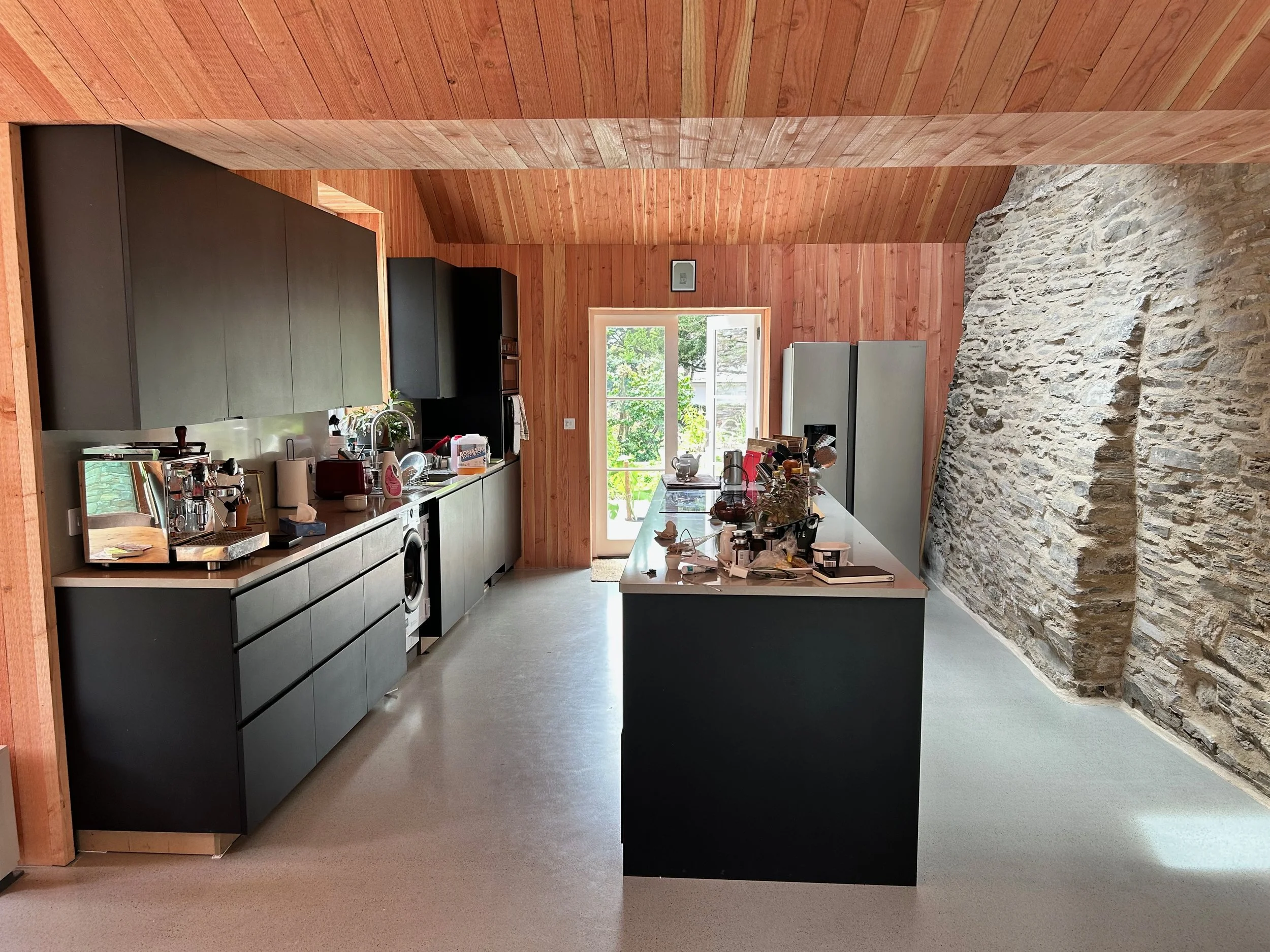 This extension creates a generous new heart to the home, bringing kitchen, dining and living spaces together in one calm, light-filled room. The design responds quietly to the character of the Manor House, using simple forms, carefully framed views a