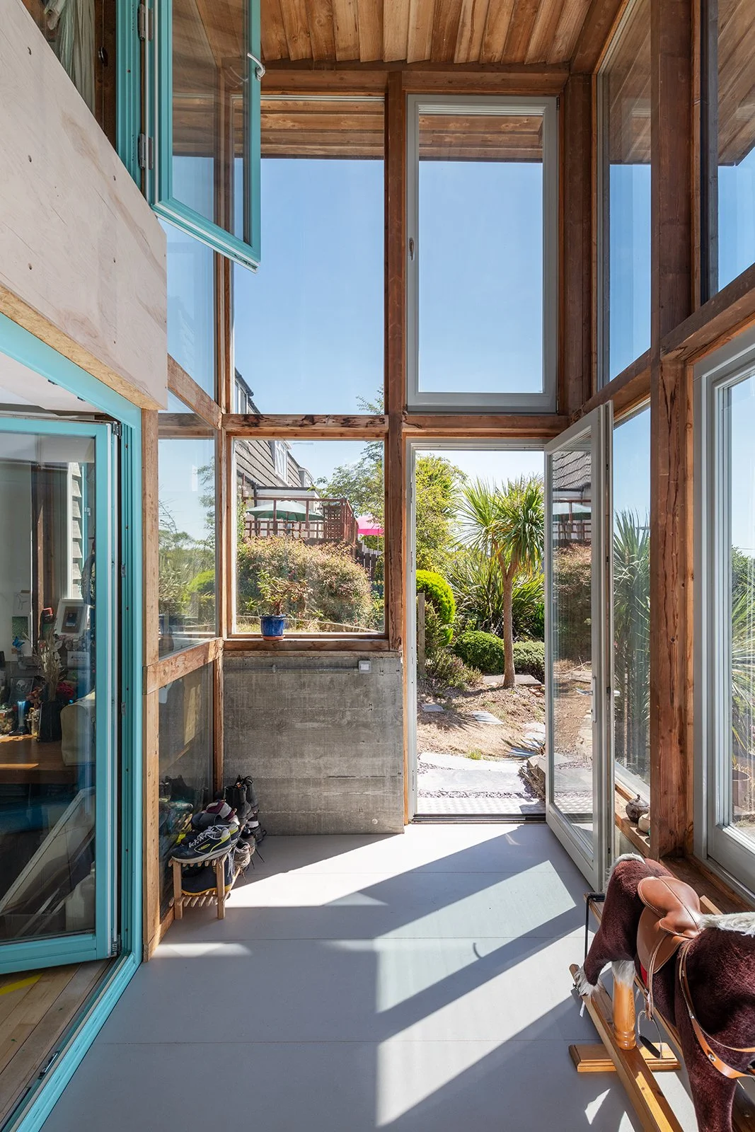 Making Light Work.  The entrance is designed as a light-filled transition between inside and out. Exposed timber framing and large areas of glazing give the space a clear structure, while high-level windows draw daylight deep into the plan. Simple ma