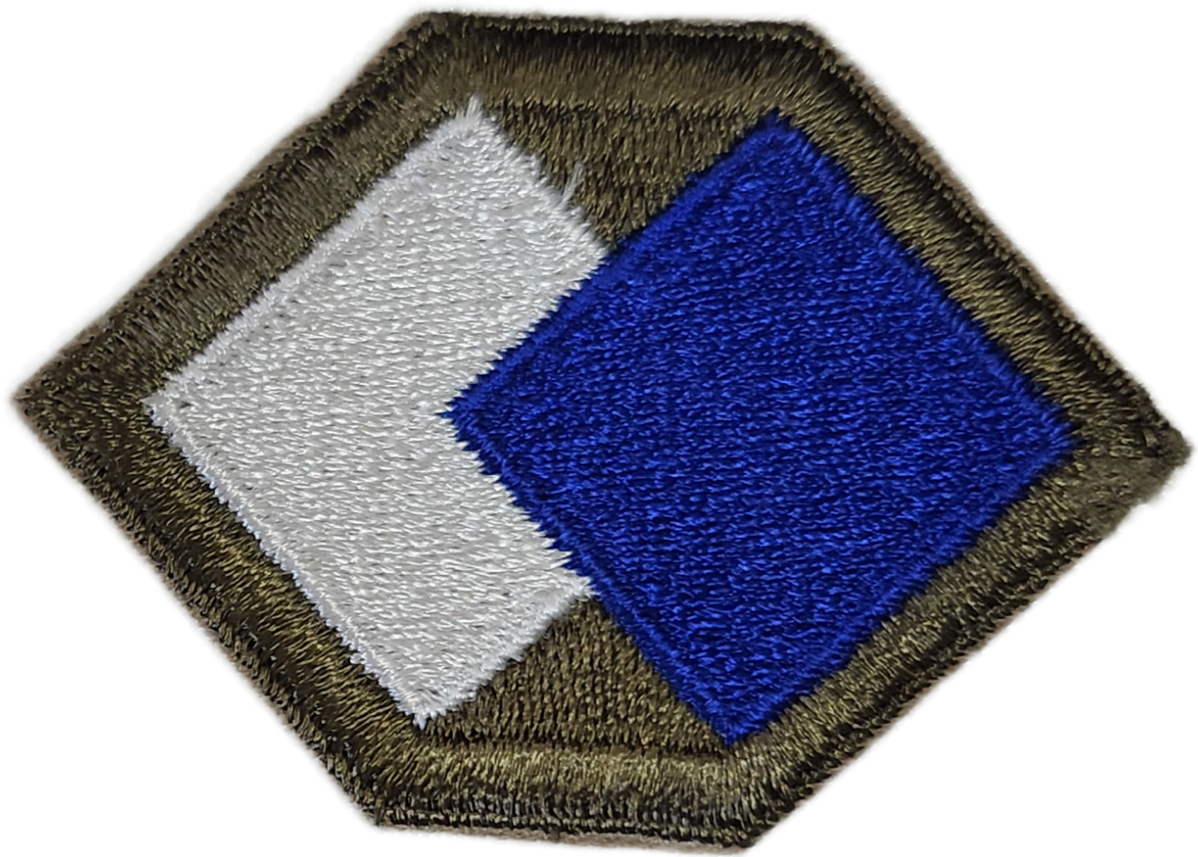 A rug with a geometric design featuring white, blue, and black colors, with a brown textured border.