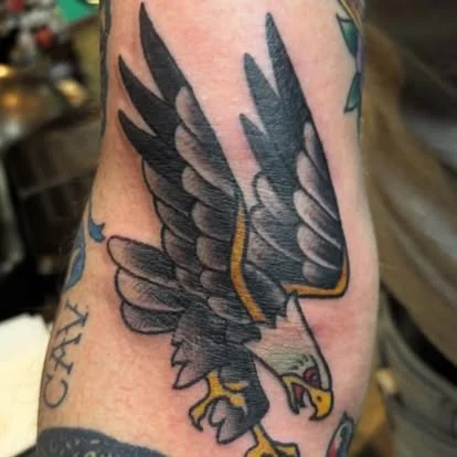 Tattoo of a flying eagle on a person's arm