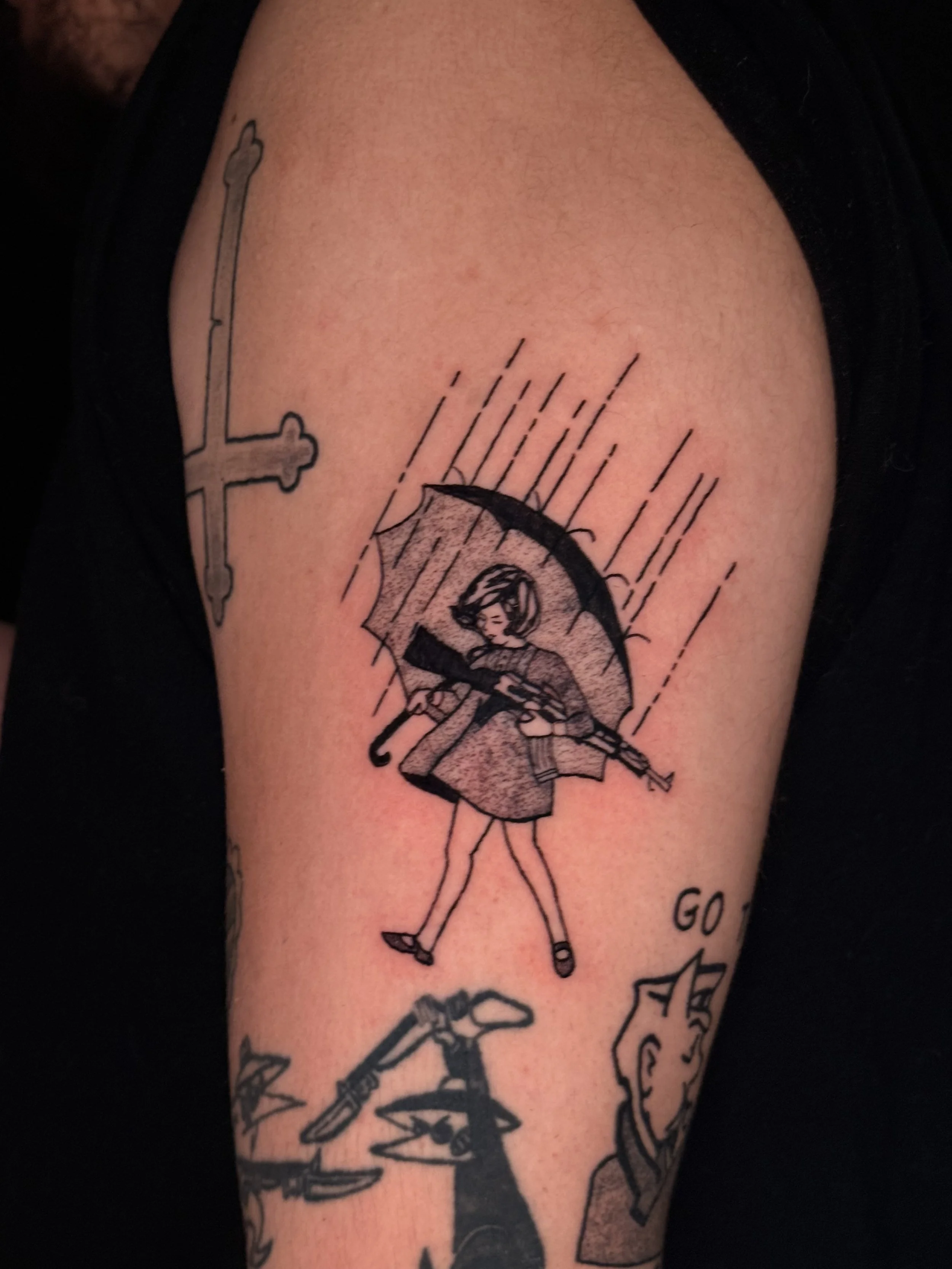 Tattoo of a girl holding an umbrella on a person's arm with rain lines above.