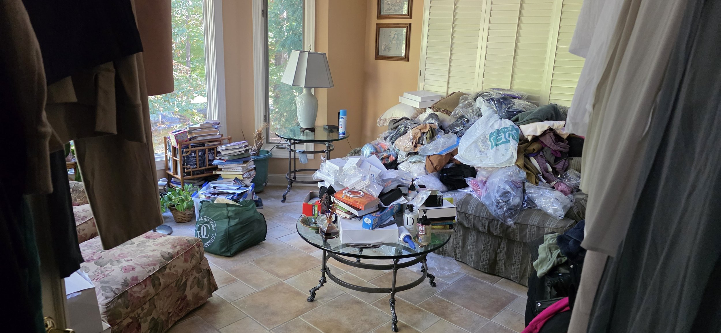 Home organizing client. Cluttered with clothes, bags, books, and household items; when overwhelm took over this became a "dumping area"
