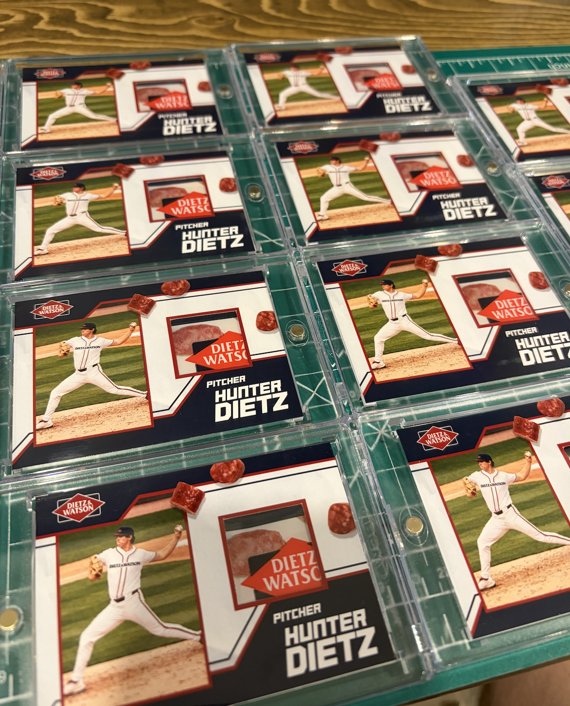 Multiple trading cards featuring pitcher Hunter Dietz in baseball uniform, with a photo of him in a pitching stance and a red and black design, inside clear plastic sleeves.
