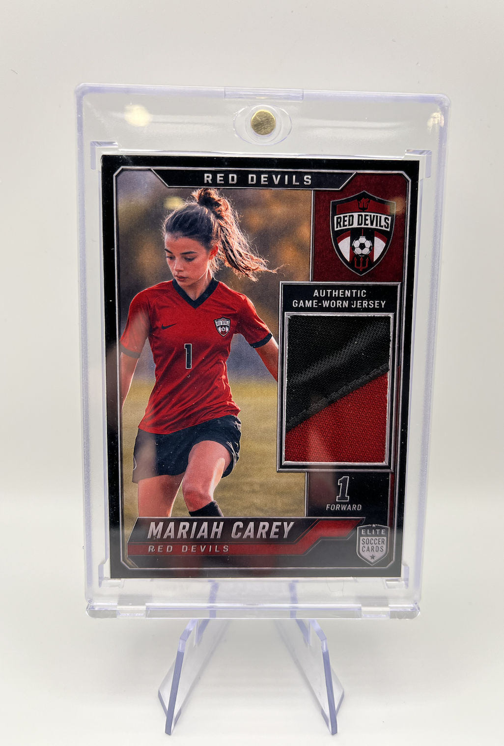 Sports trading card of Mariah Carey in her soccer uniform, featuring her in a red jersey with the number 1, from the Red Devils team.