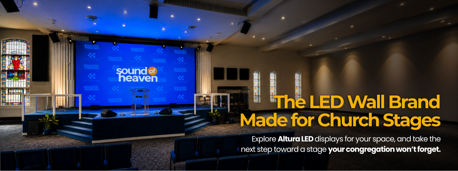 Church stage with a large blue LED wall displaying 'Sound of Heaven' and 'Altura LED'. The stage has stairs, potted plants, and black speakers, with stained glass windows on either side.