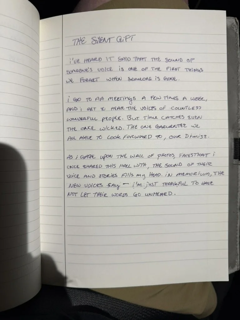 Handwritten text titled The Silent Gift on a lined notebook page.