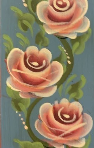 A detail of the family's original Norwegian rosemaling painting, with rose-colored flowers on a blue ground.
