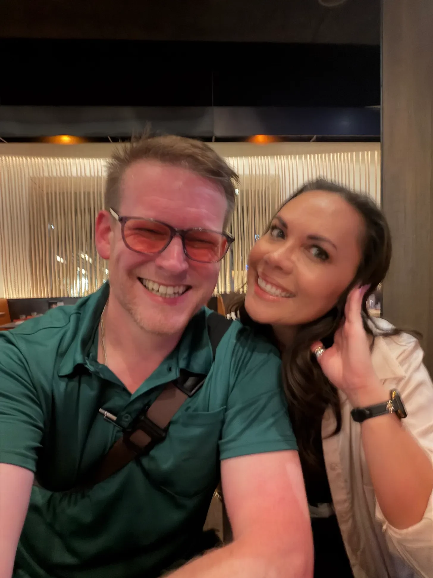 Two friends smiling for a selfie at their high school reunion.
