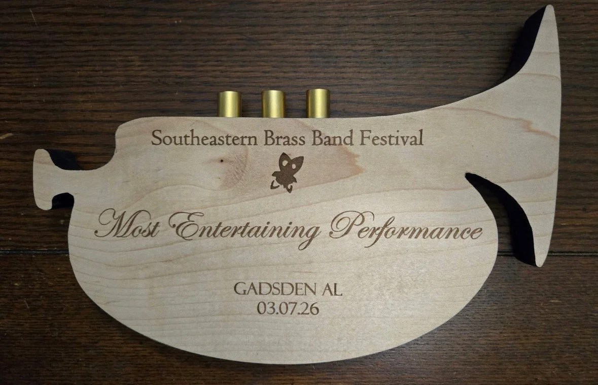 Wooden award shaped like a fish for the Southeastern Brass Band Festival, titled 'Most Entertaining Performance,' awarded to Gadsden AL on 03/07/26.
